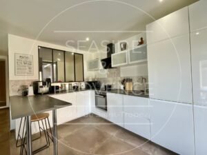 Cuisine équipée avec mobilier moderne et plan de travail fonctionnel dans un bas de villa à Sainte-Maxime.